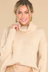 This all beige sweater features a high chunky turtle neck, ribbed detailing on the cuffs and bottom hem, and a super soft fabric.