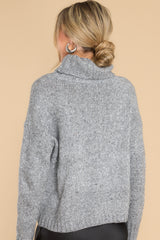 Back view of this sweater that features a high chunky turtle neck, ribbed detailing on the cuffs and bottom hem, and a super soft fabric. 