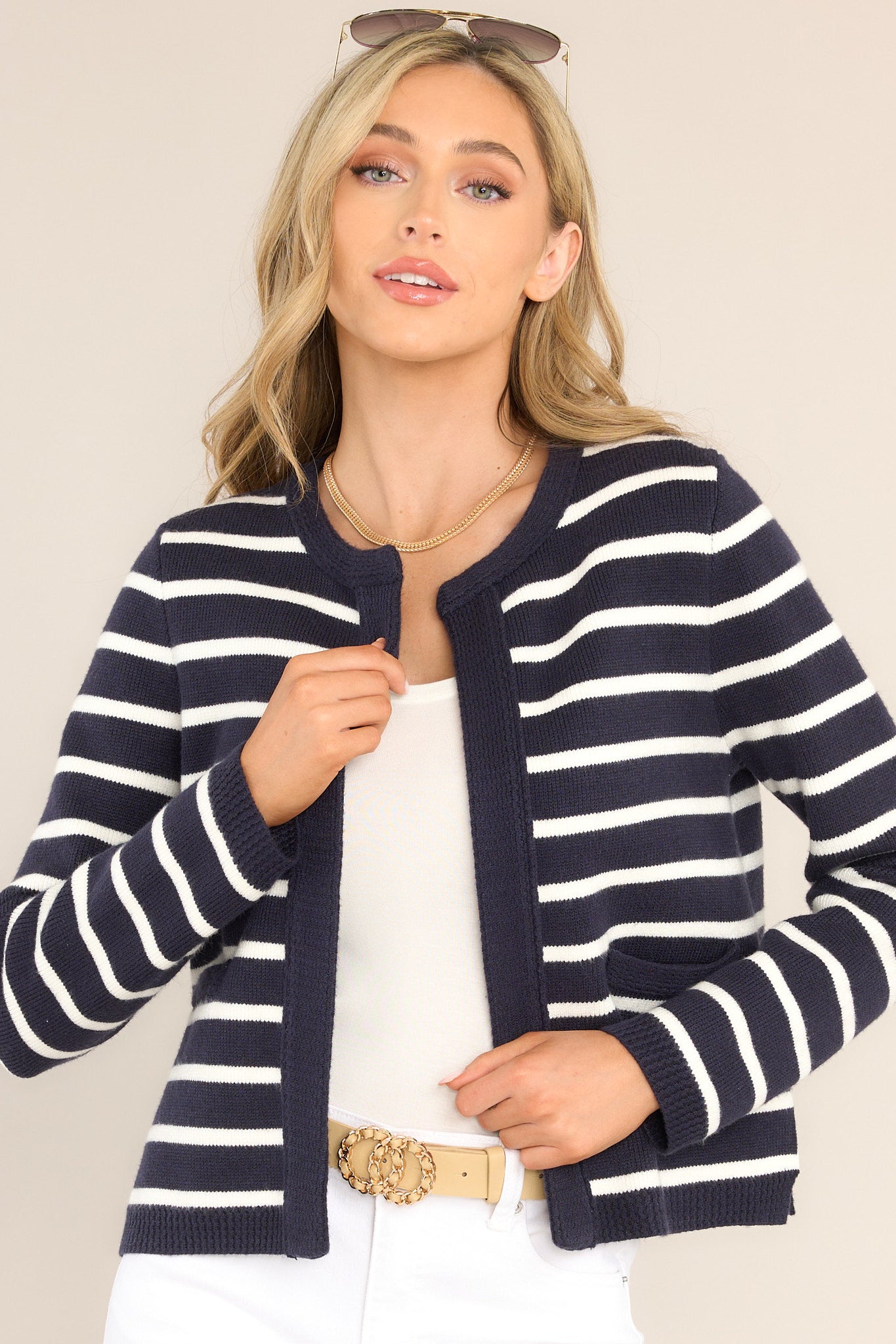 Front view of this cardigan that features a round ribbed neckline, long sleeves with ribbed cuffs, ribbed hemline, and a modern horizontal striped pattern.