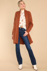 Full body view of  this cardigan that features a folded neckline that extends down the front, functional pockets, and a knit texture throughout.