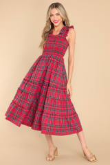 This red dress features thick ruffle straps, smocked bodice, and a tiered skirt. 