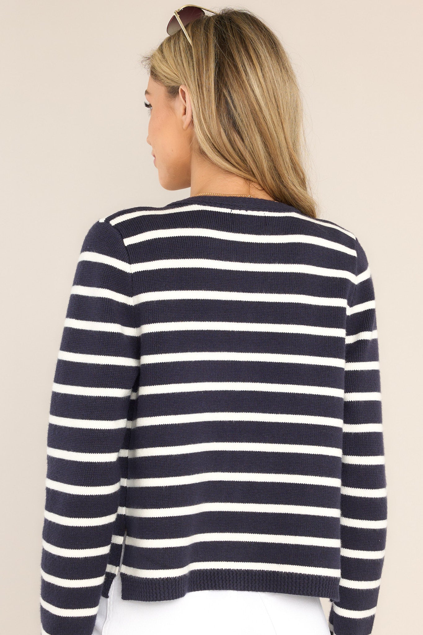 Back view of this cardigan that features a round ribbed neckline, long sleeves with ribbed cuffs, ribbed hemline, and a modern horizontal striped pattern.