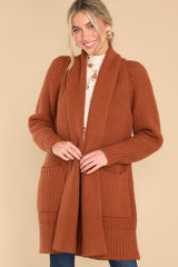 Front view of  this cardigan that features a folded neckline that extends down the front and functional pockets.