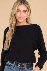 Front view of  this sweater that features a round neckline and a soft stretchy material.