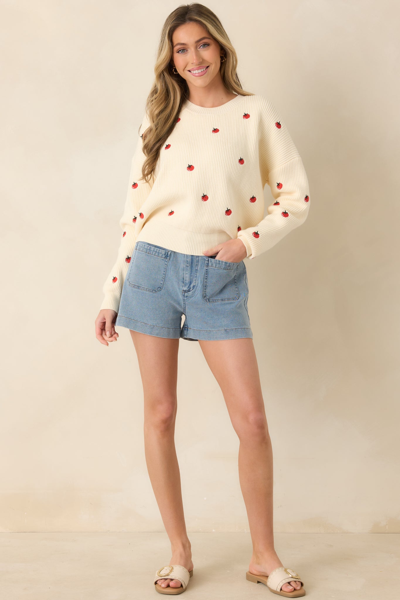 Ivory ribbed knit sweater with a crew neckline, long sleeves, and relaxed fit.