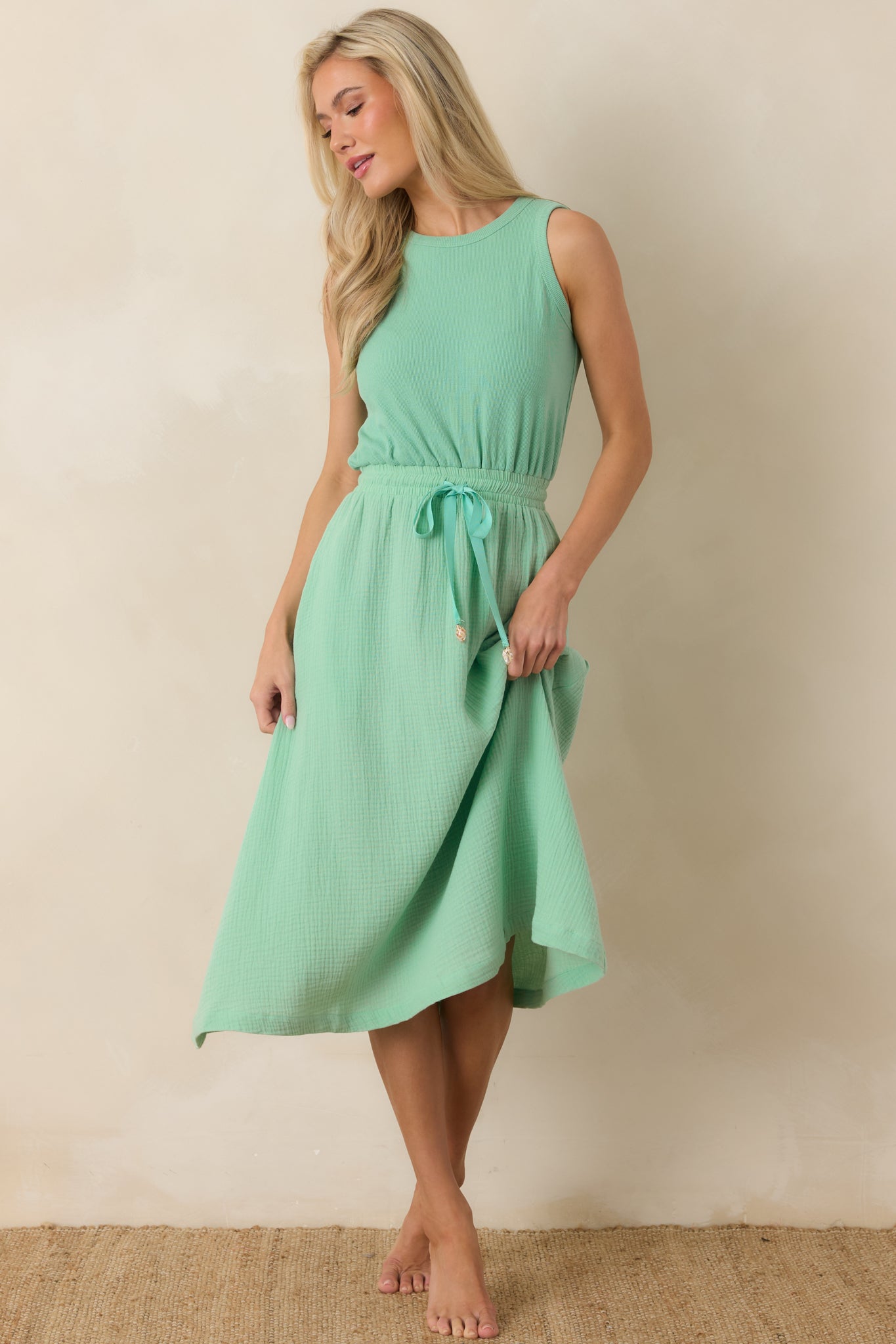 Relaxed midi dress with a round neckline and elasticized waist for a naturally flattering shape.