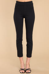 Front view of these pants that feature a seamless front, two decorative front pockets, two decorative back pockets, a natural waist, fitted hips, and skinny ankle length legs.