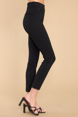 Side view of these pants that feature a seamless front, two decorative front pockets, two decorative back pockets, a natural waist, fitted hips, and skinny ankle length legs.