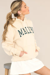 This natural colored hoodie features embroidered 