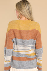 Back view of this sweater that features a crew neckline, ribbed cuffs, and an oversized fit.