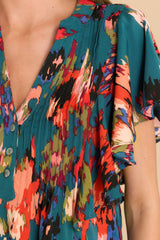 Close up view of this top that features a multi-colored vibrant pattern throughout.