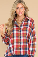 Front view of this top showcases the plaid print on the outside in shades of red, orange, blue, and white.