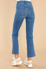 Back view of these jeans that feature a high rise design, belt loops, a slip-on style (with no zipper or button closures), non-functional front pockets, functional back pockets, and a cropped length.
