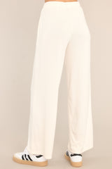 Back view of these lounge pants that feature an elastic waistband with a self-tie drawstring, pockets, and a wide leg.