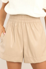 Close up view of these shorts that feature a high rise, an elastic waistband, functional pockets, and a soft feel inside.