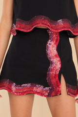 This black and red skort features a high waist, a side zipper, shorts built into the lining, and fun sequin detailing.