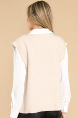 Back view of this vest that features a v-neckline, side slits, and a knit texture throughout.