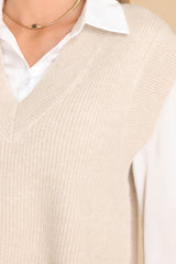 Close up view of this vest that features a v-neckline and a knit texture throughout.