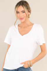 This white top features a v-neckline, short sleeves, and a lightweight fabric.