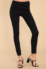 Front view of black jeans featuring a high rise design and a skinny leg. 