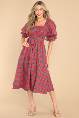 Front view of red plaid dress with functional pockets. 