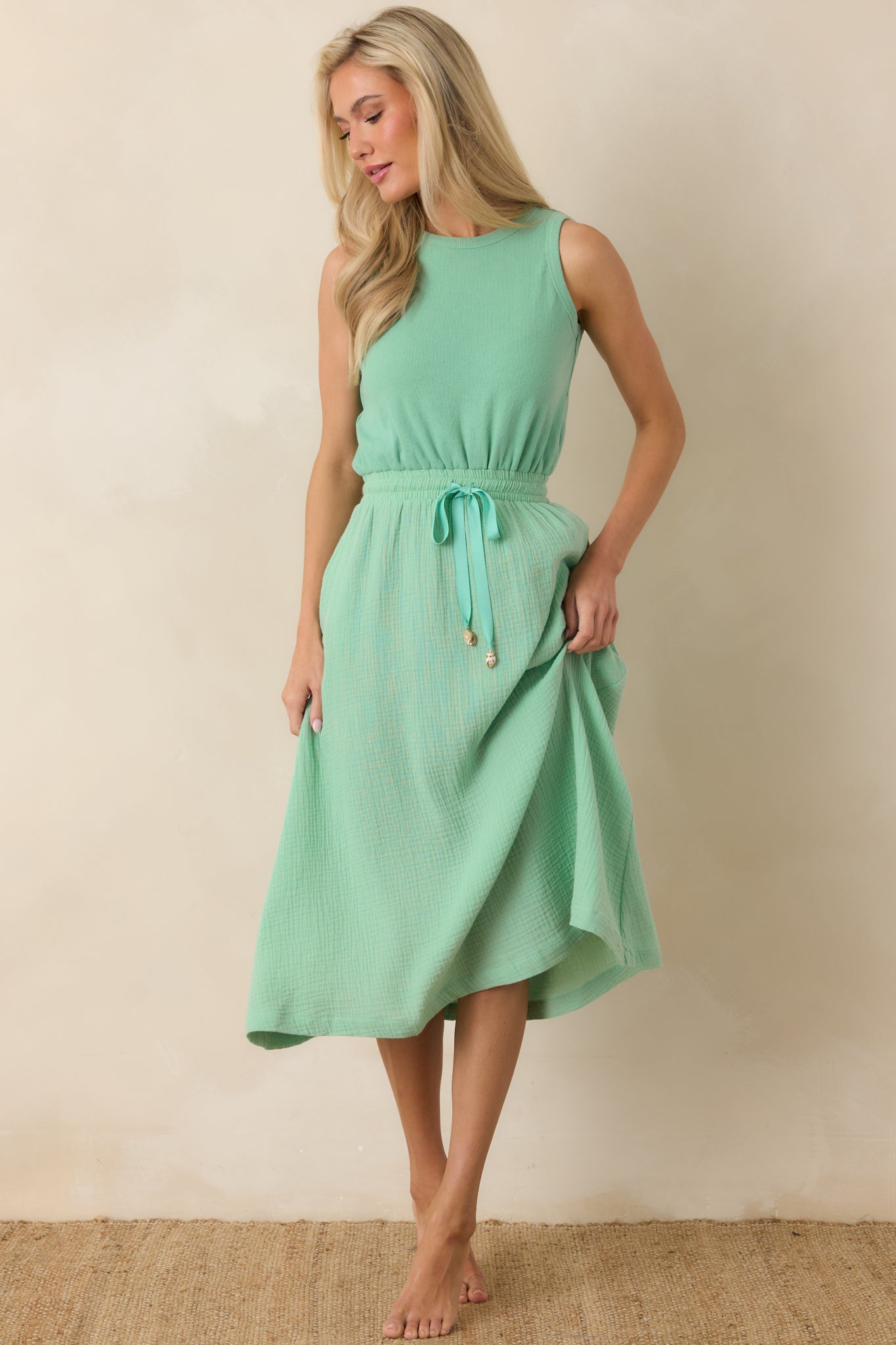Lightweight midi dress with a clean neckline, soft drape, and effortless movement.
