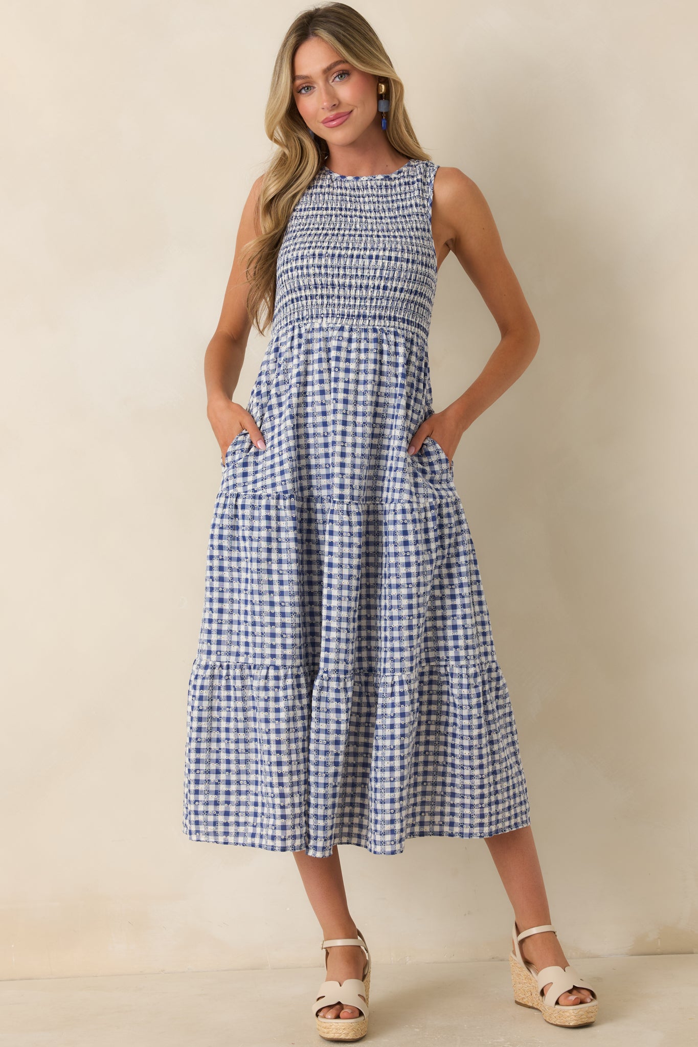 Blue cotton dress highlighting a relaxed sleeveless fit with detailed embroidery throughout.