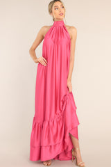 Front view of this dress that features a halter neckline with a self adjustable tie around the neck, a flowy long silhouette, and a tiered bottom.
