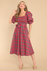 Front view of dress featuring elastic cuffed sleeves, and an all over plaid print.