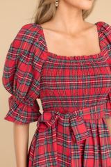 close up of red plaid midi dress with a smocked bust and puffed sleeves.