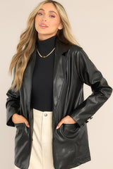 Front view of  this blazer that features a collared neckline, long sleeves with non-functional buttons on the cuffs, two functional front pockets, and two functional button closures.