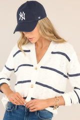 Front view of this cardigan that features a v-neckline, a functional button front, functional pockets, ribbed cuffed long sleeves, and a ribbed hemline.