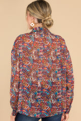 Back view of this blouse that features a collar neckline, functional buttons all the way up, and an overall loose fit.