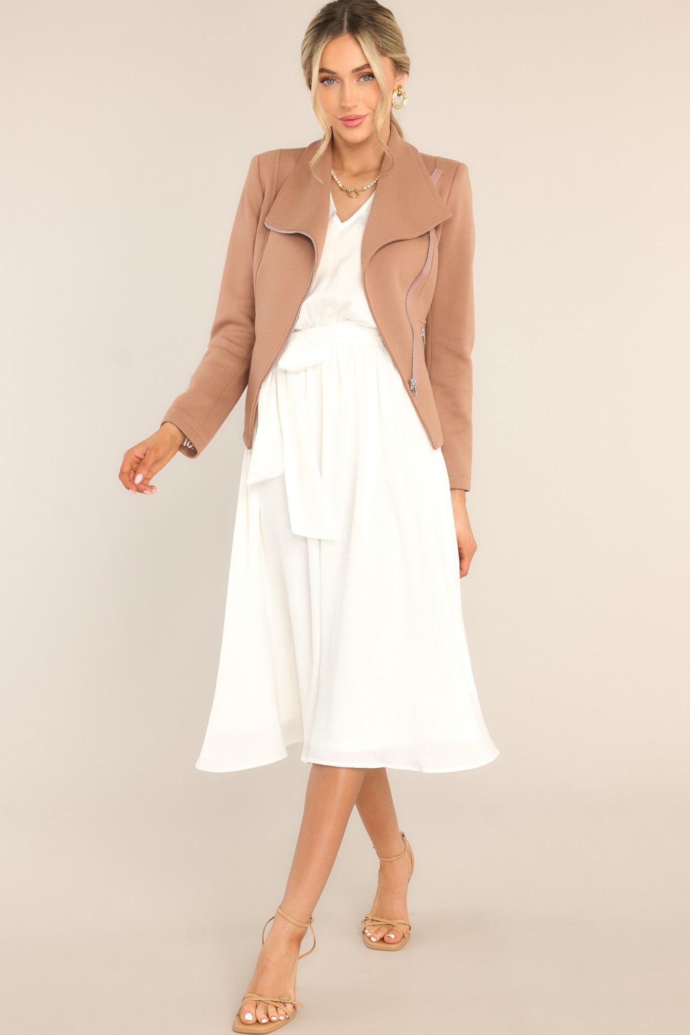 Full body view of this midi dress that features a V-neckline, an open back with a self-tie closure, flowy cap sleeves, an elastic waistband with a self-tie fabric belt, and button detailing down the side of the skirt.