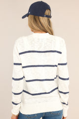 Back view of this cardigan that features a v-neckline, a functional button front, functional pockets, ribbed cuffed long sleeves, and a ribbed hemline.