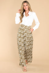 Full body view of these pants that feature a high rise design, belt loops, a zipper and double hook and eye closures, functional front pockets, and a wide, flowy leg.