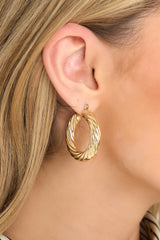 These gold hoops feature gold hardware, a twisted design, and a lever back closure.