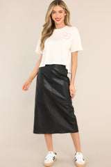 Full body view of this skirt that features a high waisted design, a side zipper, a slit in the back, and a faux leather material.