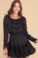 Front view of this dress that features a scoop neckline, lace detailing throughout, and an elastic band around the waist.
