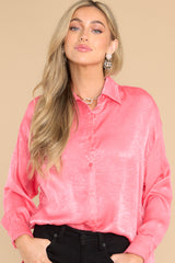 Front view of this top that features pink buttons down the front.