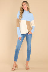 Full body view of this sweater that features a mock neckline, a color block design and a ribbed material.