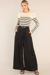 Full body view of this top that features a crew neckline, a stretchy ribbed fabric, a striped pattern, and long sleeves.