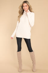 Full body view of this sweater that features a cowl turtle neckline, long sleeves with ribbed cuffs, and a bottom hem that tapers in around the hips.