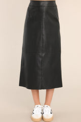 Front view of this skirt that features a high waisted design, a side zipper, a slit in the back, and a faux leather material.