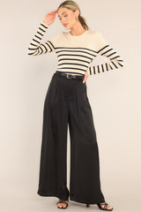 Full front view of this top that features a crew neckline, a stretchy ribbed fabric, a striped pattern, and long sleeves.