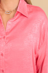 Close up view of this top that features a collared neckline, buttons down the front, buttons at the cuff, and a classic relaxed fit.