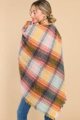 Back view of this scarf that features a plaid pattern throughout with fringe sides.