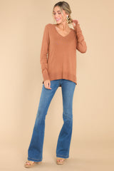 Full body view of this top that features a slight v-neckline with a raw hemline, 3.5