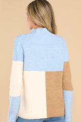 Back view of this sweater that features a mock neckline, a color block design and a ribbed material.
