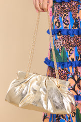 Full view of this bag that features a wide hinged opening that snaps shut (no zipper or snap button closure) , and a non-removable gold chain strap.